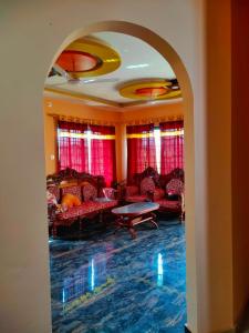 an archway in a room with couches and a table at Tathāgata Homestay in Lumbini