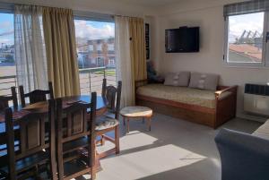 a living room with a table and a dining room at Wenuray MdQ in Mar del Plata