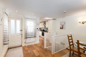 a kitchen and dining room with white walls at Stunning 3 Bed London Townhouse in London