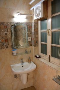 a bathroom with a sink and a window at Solan Retreat in Solan