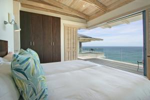 a bedroom with a bed with a view of the ocean at Beach Music in Llandudno +61 photos