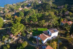 an aerial view of a house on a hill next to the ocean at Villa Caterina Quiete e Mare-Goelba in SantʼAndrea