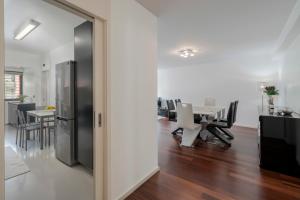 a kitchen and dining room with a table and chairs at Madalenas XXI by An Island Apart in Funchal