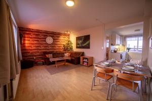 een woonkamer met een tafel en een bank bij Snæfellsjökull Apartments in Snæfellsbær