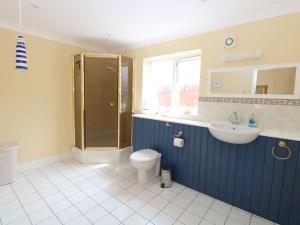 a bathroom with a shower and a toilet and a sink at Drifters in Great Yarmouth +33 photos