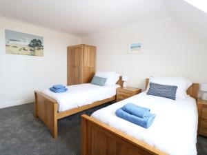 two twin beds in a room with white walls at Drifters in Great Yarmouth