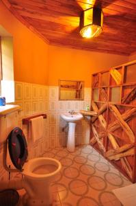 a bathroom with a toilet and a sink at Naiberi River Campsite & Resort in Eldoret