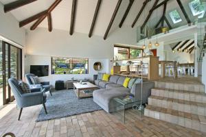 a living room with a couch and a table at Beach Music in Llandudno