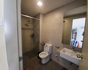 a bathroom with a toilet and a sink at Bali Residence Impian Raudah in Melaka