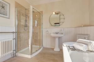 a bathroom with a shower and a sink at Fabulous Seaside Retreat in Hunstanton +31 photos