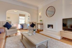 a living room with a couch and a table at Fabulous Seaside Retreat in Hunstanton