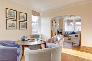 a living room with a table and chairs at Fabulous Seaside Retreat in Hunstanton