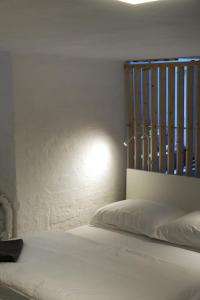 a bedroom with a white bed with a metal headboard at Central, cozy & beautiful designed 2-rooms Apt. near river in Berlin