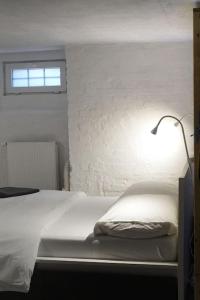 a bedroom with a bed with a lamp on it at Central, cozy & beautiful designed 2-rooms Apt. near river in Berlin