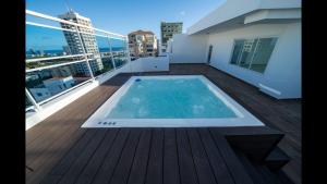 a balcony with a swimming pool on top of a building at Sdq, Gym, Pool, 1br 2B, Downtown F7 in Santo Domingo
