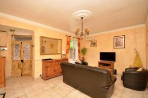 a living room with a couch and a television at Cosy Antibes villa in Antibes