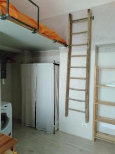 a room with a bunk bed and a refrigerator at Marsò _ Piccolo rifugio cittadino in Turin