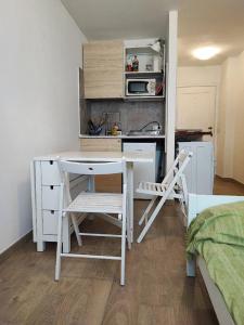 a small kitchen with a desk and a sink at La Casa di Giorgia in Sestriere