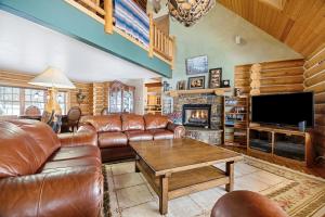 a living room with leather furniture and a fireplace at Ranch Home in Glenwood Springs