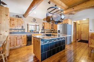 a large kitchen with wooden cabinets and a large island at Ranch Home in Glenwood Springs