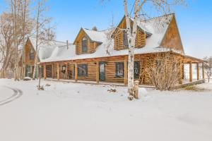 a log cabin in the snow with snow at Ranch Home in Glenwood Springs