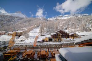 a ski lodge in the mountains with snow on the ground at Walsertal Residence in Gressoney-la-Trinité