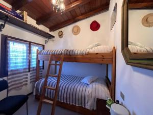 two bunk beds in a room with a mirror at La Baita Di San Massimo in Rapallo