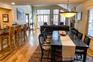 a dining room and living room with a table and chairs at River Retreat - Permit #3517 in Estes Park