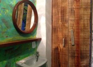 a bathroom with a mirror and a sink at PARA TI GUESTHOUSE in Rio de Janeiro