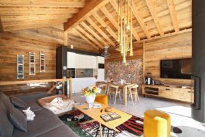 a living room with a couch and a table at Chalet le 1700 in Les Deux Alpes