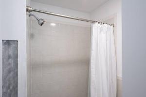 a shower with a white shower curtain in a bathroom at 428-3R Spacious Prime Midtown 2BR Newly furnished in New York