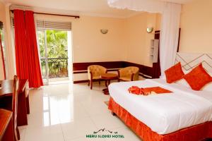 a hotel room with two beds and a desk at Meru Slopes Hotel in Meru