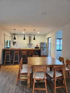 a dining room and kitchen with a wooden table and chairs at Casa de campo en Tupungato, Mendoza. in Tupungato