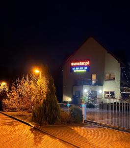 a suntrust gas station at night with a lit up sign at SunStar in Rewal