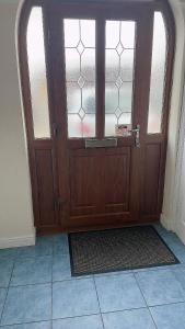 a wooden door with a window in a room at Spacious Double Room in Leicester