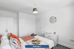 a white bedroom with a bed and a mirror at Wolverhampton - Amazing 3 Bedroom, Sleeps 6, Wi-Fi - JRR Stays in Fallings Park