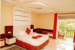 a hotel room with a bed and a balcony at Meru Slopes Hotel in Meru