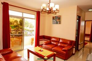 a living room with a couch and a table at Meru Slopes Hotel in Meru