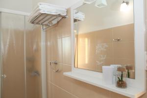 a bathroom with a shower and a mirror at Apartments Sea View Kozino in Kožino