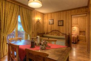a bedroom with a table and a bed in a room at B&B Residence Checrouit in Courmayeur