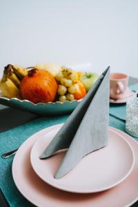 a knife on a plate with a plate of fruit at LUMA in Zagreb