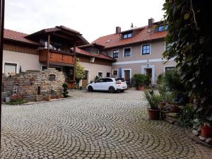a white car parked in front of a building at Lukashof in Waldmünchen