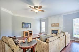 a living room with a couch and a ceiling fan at Chic Gastonia Home with Deck, Fire Pit and Grill! in Gastonia