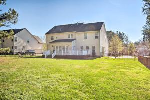 a large white house with a yard at Chic Gastonia Home with Deck, Fire Pit and Grill! in Gastonia