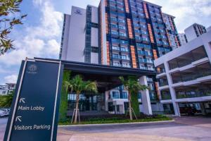 a building with a sign in front of it at LovelySea Holiday TimurBay 1R1B condo 4pax恋恋海之屋度假村 in Kuantan