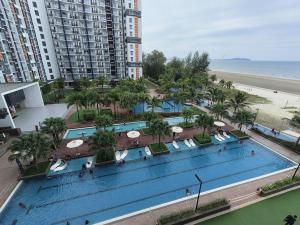 an overhead view of a large swimming pool next to a beach at LovelySea Holiday TimurBay 1R1B condo 4pax恋恋海之屋度假村 in Kuantan