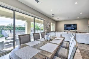 a dining room with a table and chairs and a television at Elegant Indio Home with Private Pool and Spa! in Indio