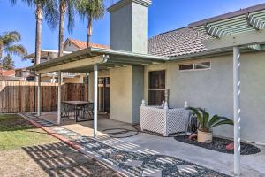 a house with a patio with a table and a fence at Family-Friendly Getaway Community Amenities! in Bakersfield