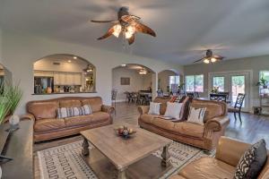 a living room with couches and a ceiling fan at Lavish Family Escape with Game Room in Avondale! in Avondale