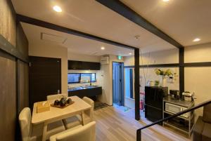 a kitchen and a living room with a table and chairs at Miyanonoki guest house with Free Parking in Tokyo